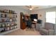 Comfortable home office equipped with built-in shelves, a desk, and comfortable seating for remote work at 1777 Chasewood Park Ln, Marietta, GA 30066