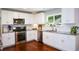 Modern kitchen with white cabinets, stainless steel appliances, and granite countertops at 1777 Chasewood Park Ln, Marietta, GA 30066