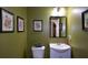 Powder room features decorative art and a modern vanity at 1777 Chasewood Park Ln, Marietta, GA 30066