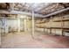 Unfinished basement with exposed ceiling, shelves, and pipes at 2201 Bollingbrook Drive, Atlanta, GA 30311