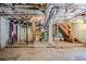 Unfinished basement with exposed ceiling and stairs at 2201 Bollingbrook Drive, Atlanta, GA 30311
