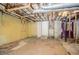 Unfinished basement with exposed ceiling, concrete floor, and door to the outside at 2201 Bollingbrook Drive, Atlanta, GA 30311