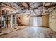 Unfinished basement with exposed ceiling, stairs, and door to the outside at 2201 Bollingbrook Drive, Atlanta, GA 30311