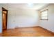 A bedroom with hardwood floors, a window, and a closet at 2201 Bollingbrook Drive, Atlanta, GA 30311