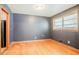 Cozy dining room features hardwood floors, a window for natural light, and dark painted walls at 2201 Bollingbrook Drive, Atlanta, GA 30311