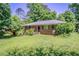 Quaint brick ranch-style home with a well-kept lawn, mature shrubs, and a welcoming facade at 2201 Bollingbrook Drive, Atlanta, GA 30311