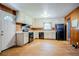 A kitchen with wood paneling, linoleum flooring, white cabinets, and black appliances at 2201 Bollingbrook Drive, Atlanta, GA 30311