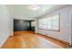 Sunlit living room with hardwood floors, large windows, and fresh neutral paint, offering a bright open space at 2201 Bollingbrook Drive, Atlanta, GA 30311