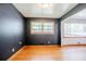 Spacious room with hardwood floors, complemented by dark painted walls and large windows, creating a cozy atmosphere at 2201 Bollingbrook Drive, Atlanta, GA 30311