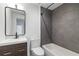 Modern bathroom with gray tiled shower, dark vanity, and white toilet at 367 Parkway Ne Dr # 4, Atlanta, GA 30312