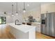 Modern kitchen with stainless steel appliances, a spacious island, and contemporary pendant lighting at 367 Parkway Ne Dr # 4, Atlanta, GA 30312
