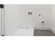 Clean, simple laundry area with gray tile flooring and white walls at 367 Parkway Ne Dr # 4, Atlanta, GA 30312