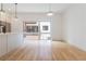Open-concept living area with hardwood floors, modern lighting, and a view of the kitchen and backyard at 367 Parkway Ne Dr # 4, Atlanta, GA 30312
