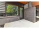 Cozy outdoor patio area with brick walls, concrete flooring, and views of the surrounding greenery at 367 Parkway Ne Dr # 4, Atlanta, GA 30312