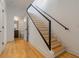 Modern staircase with wood treads and a sleek metal railing leading to the upper level at 367 Parkway Ne Dr # 4, Atlanta, GA 30312
