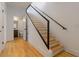 Bright staircase with hardwood steps, metal railing, and access to a bathroom at 367 Parkway Ne Dr # 4, Atlanta, GA 30312