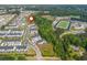 Aerial view of a neighborhood near a sports complex with a football field and baseball field, and lush greenery at 996 Layton Dr, Buford, GA 30518