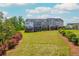 Townhome backyard featuring a well-maintained lawn and landscaping at 996 Layton Dr, Buford, GA 30518