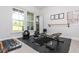 Bright home gym featuring large windows, ample workout equipment, and rubber flooring at 996 Layton Dr, Buford, GA 30518