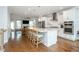 Modern, open kitchen with large island, stainless steel appliances, white cabinetry, and hardwood floors at 996 Layton Dr, Buford, GA 30518