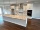 Bright kitchen with white cabinets, stainless steel appliances, and a spacious island at 996 Layton Dr, Buford, GA 30518