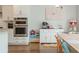 Bright kitchen nook featuring a breakfast bar, stainless steel double oven, and an adjacent dining area at 996 Layton Dr, Buford, GA 30518