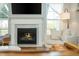 Bright living room features a fireplace, large windows, hardwood floors, and modern decor at 996 Layton Dr, Buford, GA 30518