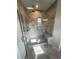 Large walk-in shower with glass door and bench, tiled with gray brick-patterned marble and rainfall shower head at 996 Layton Dr, Buford, GA 30518