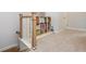 Staircase landing featuring a custom bookshelf filled with colorful books and white carpet at 996 Layton Dr, Buford, GA 30518