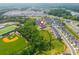 An aerial view of townhomes near a school and green spaces in a Gathering-friendly community at 996 Layton Drive Dr, Buford, GA 30518