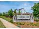 Entrance to Northmark community with stone sign, landscaping, and clear blue sky at 996 Layton Drive Dr, Buford, GA 30518