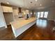 Modern kitchen featuring a large island, stainless steel appliances, and hardwood floors at 996 Layton Drive Dr, Buford, GA 30518