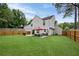 Wide angle of backyard showcasing open space and privacy fence at 1047 Woodsong Pass Ct, Lawrenceville, GA 30043