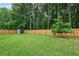 Spacious backyard with a well-maintained lawn and privacy fence at 1047 Woodsong Pass Ct, Lawrenceville, GA 30043