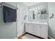 Bathroom featuring a double sink vanity with modern lighting and fixtures at 1047 Woodsong Pass Ct, Lawrenceville, GA 30043