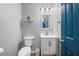 Charming half bath features a modern vanity and bright blue door at 1047 Woodsong Pass Ct, Lawrenceville, GA 30043