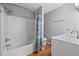 Bathroom featuring a tub and shower combination with modern fixtures at 1047 Woodsong Pass Ct, Lawrenceville, GA 30043