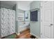 Bright bathroom featuring a tub with shower and modern fixtures at 1047 Woodsong Pass Ct, Lawrenceville, GA 30043