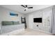 Bedroom with modern decor, including a daybed, television, and window with natural light at 1047 Woodsong Pass Ct, Lawrenceville, GA 30043