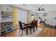 Bright dining area features a wooden table, four chairs, and a view to the backyard at 1047 Woodsong Pass Ct, Lawrenceville, GA 30043