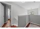 Hallway with stairway and access to bathroom at 1047 Woodsong Pass Ct, Lawrenceville, GA 30043
