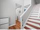 Inviting home entryway featuring hardwood floors, neutral gray walls, and a staircase leading to the upper level at 1047 Woodsong Pass Ct, Lawrenceville, GA 30043
