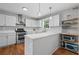Well-lit kitchen with white cabinetry, stainless steel appliances, and a spacious countertop at 1047 Woodsong Pass Ct, Lawrenceville, GA 30043