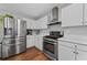 Spacious kitchen features stainless steel appliances and plenty of counter space at 1047 Woodsong Pass Ct, Lawrenceville, GA 30043