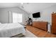 Airy main bedroom with vaulted ceiling, wood floors, and plenty of space for a home office at 1047 Woodsong Pass Ct, Lawrenceville, GA 30043