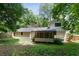 Wide backyard view of the rear of the home with a screened porch and fenced yard at 3308 Quail Run Sw Sw Run, Marietta, GA 30008