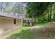 View of the rear of the home with a screened porch surrounded by a wooded lot at 3308 Quail Run Sw Sw Run, Marietta, GA 30008