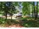 Wide backyard view of the rear of the home with a screened porch and fenced yard at 3308 Quail Run Sw Sw Run, Marietta, GA 30008