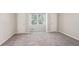 Spacious bedroom with carpet flooring, neutral walls, a large window, and closet at 3308 Quail Run Sw Sw Run, Marietta, GA 30008