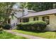 Beautiful home with lush landscaping, decorative shutters and white brick at 3308 Quail Run Sw Sw Run, Marietta, GA 30008
